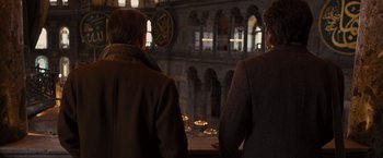 Movie still from “Argo” (2012), directed by Ben Affleck – Two men standing in front of an old building; Medium shot, Over the shoulder angle