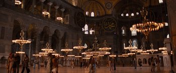 Movie still from “Argo” (2012), directed by Ben Affleck – A group of people walking around a large building; Extreme Wide shot, Low angle