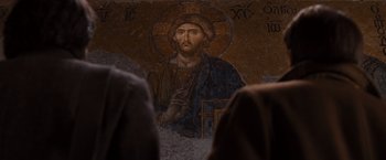 Movie still from “Argo” (2012), directed by Ben Affleck – A picture of jesus is on the wall of a church; Close Up shot, Over the shoulder angle