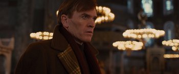 Movie still from “Argo” (2012), directed by Ben Affleck – A person wearing a coat and a scarf; Close Up shot, Low angle