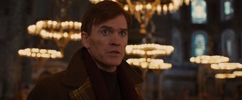 Movie still from “Argo” (2012), directed by Ben Affleck – A person wearing a scarf; Close Up shot, Over the shoulder angle