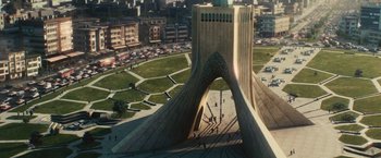 Movie still from “Argo” (2012), directed by Ben Affleck – An aerial view of a city with a large building; Extreme Wide shot, High angle