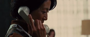 Movie still from “Argo” (2012), directed by Ben Affleck – A woman talking on a phone while wearing a white headband; Close Up shot, Low angle