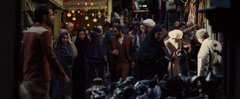Movie still from “Argo” (2012), directed by Ben Affleck – A group of people walking through a market area; Wide shot, High angle