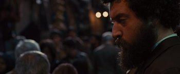 Movie still from “Argo” (2012), directed by Ben Affleck – A man with a long beard is looking into the distance; Close Up shot, Over the shoulder angle