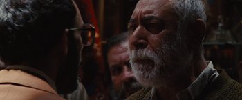 Movie still from “Argo” (2012), directed by Ben Affleck – An old man with a beard; Close Up shot, Over the shoulder angle