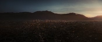 Movie still from “Argo” (2012), directed by Ben Affleck – A view of a large city at night with lights on; Extreme Wide shot, High angle