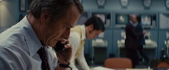 Movie still from “Argo” (2012), directed by Ben Affleck – A man and a woman on the phone in an office setting; Close Up shot, Over the shoulder angle