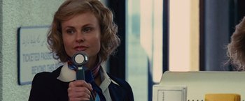 Movie still from “Argo” (2012), directed by Ben Affleck – A woman holding a stethoscope up to her mouth; Close Up shot, Over the shoulder angle