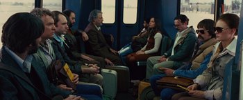 Movie still from “Argo” (2012), directed by Ben Affleck – A group of people sitting on a train; Wide shot, High angle