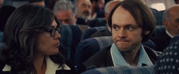 Movie still from “Argo” (2012), directed by Ben Affleck – A man and a woman sitting on a plane; Close Up shot, Over the shoulder angle