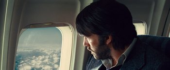 Movie still from “Argo” (2012), directed by Ben Affleck – A man looking out the window of an airplane; Close Up shot, Low angle