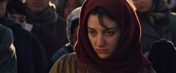 Movie still from “Argo” (2012), directed by Ben Affleck – A woman wearing a head scarf and a brown jacket; Close Up shot, Low angle