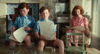 Movie still from “Atonement” (2007), directed by Joe Wright – A group of children sitting in a living room; Medium shot, High angle