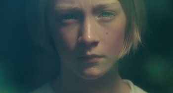 Movie still from “Atonement” (2007), directed by Joe Wright – A young girl with blue eyes stares into the camera; Extreme Close Up shot, High angle