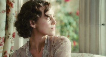 Movie still from “Atonement” (2007), directed by Joe Wright – A woman sitting in front of a window looking off into the distance; Close Up shot, Over the shoulder angle