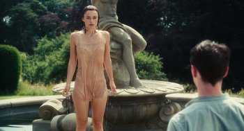 Movie still from “Atonement” (2007), directed by Joe Wright – A woman is standing in front of a fountain; Medium shot, Over the shoulder angle
