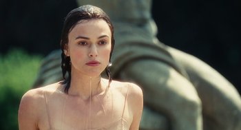 Movie still from “Atonement” (2007), directed by Joe Wright – A beautiful woman with long black hair standing in front of a statue; Close Up shot, Over the shoulder angle