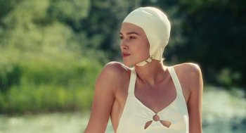 Movie still from “Atonement” (2007), directed by Joe Wright – A woman in a white bathing suit with a white hat; Close Up shot, Over the shoulder angle
