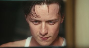 Movie still from “Atonement” (2007), directed by Joe Wright – A man's face looking into a mirror; Close Up shot, Low angle