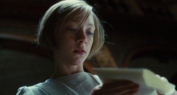 Movie still from “Atonement” (2007), directed by Joe Wright – A young girl is looking at her cell phone; Close Up shot, Low angle
