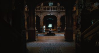 Movie still from “Atonement” (2007), directed by Joe Wright – A person standing in the middle of a room; Extreme Wide shot, Low angle