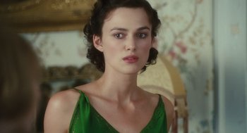 Movie still from “Atonement” (2007), directed by Joe Wright – A woman in a green dress is looking at the camera; Close Up shot, Over the shoulder angle