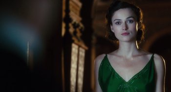 Movie still from “Atonement” (2007), directed by Joe Wright – A woman in a green dress standing next to a window; Close Up shot, Over the shoulder angle