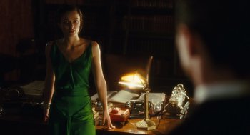 Movie still from “Atonement” (2007), directed by Joe Wright – A woman standing in front of a table with a lit candle; Medium shot, Over the shoulder angle