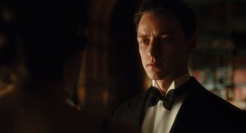 Movie still from “Atonement” (2007), directed by Joe Wright – A person wearing a suit and bow tie; Close Up shot, Low angle