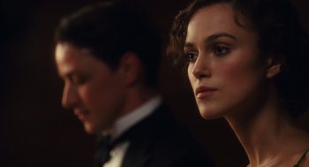 Movie still from “Atonement” (2007), directed by Joe Wright – A man and a woman are standing side by side; Close Up shot, Over the shoulder angle
