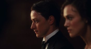 Movie still from “Atonement” (2007), directed by Joe Wright – A man and a woman in a suit and bow tie; Close Up shot, Low angle