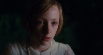 Movie still from “Atonement” (2007), directed by Joe Wright – A young girl is looking into the camera; Close Up shot, High angle