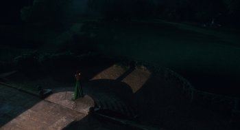 Movie still from “Atonement” (2007), directed by Joe Wright – A person standing on a platform in the dark; Extreme Wide shot, High angle