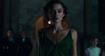 Movie still from “Atonement” (2007), directed by Joe Wright – A woman in a green dress standing in front of a wall; Close Up shot, Low angle