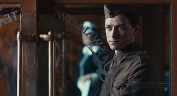 Movie still from “Atonement” (2007), directed by Joe Wright – A man in a military uniform standing in front of a mirror; Close Up shot, Low angle