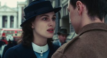 Movie still from “Atonement” (2007), directed by Joe Wright – A woman wearing a hat and a jacket; Close Up shot, Over the shoulder angle