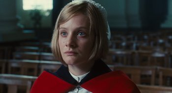 Movie still from “Atonement” (2007), directed by Joe Wright – A woman in a red and white dress with a white hat; Close Up shot, Low angle