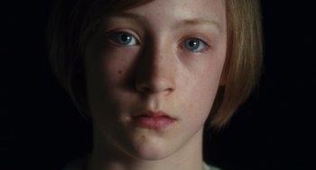 Movie still from “Atonement” (2007), directed by Joe Wright – A young girl's face with blue eyes; Close Up shot, High angle