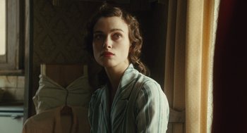 Movie still from “Atonement” (2007), directed by Joe Wright – A woman in a striped shirt is looking at the camera; Close Up shot, Over the shoulder angle