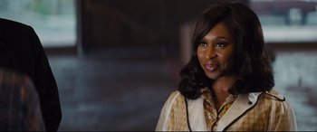 Movie still from “Bad Times at the El Royale” (2018), directed by Drew Goddard – A person smiling for the camera; Close Up shot, Over the shoulder angle