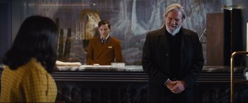 Movie still from “Bad Times at the El Royale” (2018), directed by Drew Goddard – A man standing in front of a counter next to another man; Medium shot, Over the shoulder angle