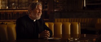 Movie still from “Bad Times at the El Royale” (2018), directed by Drew Goddard – An older man sitting at a table in a restaurant; Medium shot, Over the shoulder angle