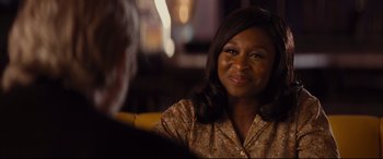 Movie still from “Bad Times at the El Royale” (2018), directed by Drew Goddard – A woman sitting in front of a man in front of a window; Close Up shot, Over the shoulder angle