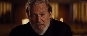 Movie still from “Bad Times at the El Royale” (2018), directed by Drew Goddard – An older man with a beard looking at the camera; Close Up shot, Over the shoulder angle