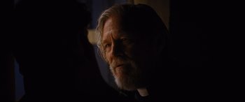 Movie still from “Bad Times at the El Royale” (2018), directed by Drew Goddard – An old man with a beard and a white beard; Close Up shot, Over the shoulder angle