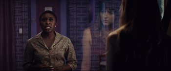 Movie still from “Bad Times at the El Royale” (2018), directed by Drew Goddard – Two women standing next to each other in front of a window; Medium shot, Over the shoulder angle