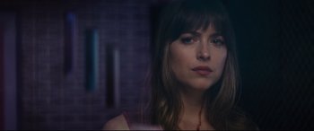 Movie still from “Bad Times at the El Royale” (2018), directed by Drew Goddard – A person wearing a necklace; Close Up shot, Over the shoulder angle