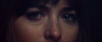 Movie still from “Bad Times at the El Royale” (2018), directed by Drew Goddard – A person's eyes with green eyes; Extreme Close Up shot, Overhead angle