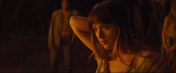 Movie still from “Bad Times at the El Royale” (2018), directed by Drew Goddard – A beautiful young woman with long brown hair; Medium shot, Over the shoulder angle